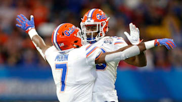 ATLANTA, GEORGIA - DECEMBER 29: Jeremiah Moon #7 and Chauncey Gardner-Johnson #23 of the Florida Gators celebrate a stopage on fourth down in the first quarter against the Michigan Wolverines during the Chick-fil-A Peach Bowl at Mercedes-Benz Stadium on December 29, 2018 in Atlanta, Georgia. (Photo by Mike Zarrilli/Getty Images)