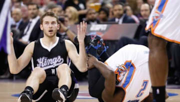 Dec 16, 2014; Sacramento, CA, USA; Sacramento Kings guard Nik Stauskas (10) reacts after being called for a foul against Oklahoma City Thunder guard Anthony Morrow (2) during the second quarter at Sleep Train Arena. Mandatory Credit: Kelley L Cox-USA TODAY Sports