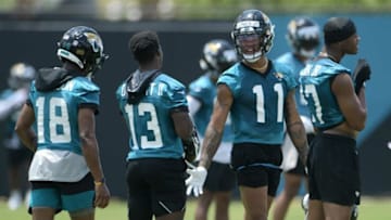 Jaguars (11) WR Marvin Jones Jr. talks with teammate (13) WR Phillip Dorsett II during drills at Thursday's OTA session. The Jacksonville Jaguars held their Thursday session of organized team activity at the practice fields outside TIAA Bank Field, May 27, 2021.Jki 052721 Jagsotas 15