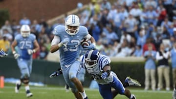 Nov 7, 2015; Chapel Hill, NC, USA; North Carolina Tar Heels wide receiver Mack Hollins (13) runs as Duke Blue Devils cornerback Alonzo Saxton II (21) defends in the third quarter at Kenan Memorial Stadium. Mandatory Credit: Bob Donnan-USA TODAY Sports