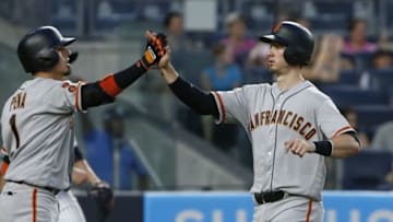 Jul 23, 2016; Bronx, NY, USA; San Francisco Giants third baseman Ramiro Pena (1) gives San Francisco Giants catcher Trevor Brown (14) a high five after scoring the game winning run in the twelfth inning at Yankee Stadium. Mandatory Credit: Noah K. Murray-USA TODAY Sports