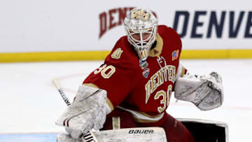 BUFFALO, NEW YORK - APRIL 11: Filip Larsson #30 of the Denver Pioneers stops a shot in the overtime period against the Massachusetts Minutemen during the semifinals of the NCAA Men's Frozen Four at KeyBank Center on April 11, 2019 in Buffalo, New York.The Massachusetts Minutemen defeated the Denver Pioneers 4-3 in overtime. (Photo by Elsa/Getty Images)