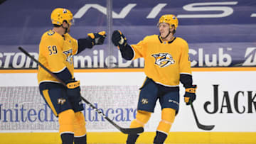 Mar 25, 2021; Nashville, Tennessee, USA; Nashville Predators right wing Eeli Tolvanen (28) celebrates with Nashville Predators defenseman Roman Josi (59) after a power play goal during the first period against the Detroit Red Wings at Bridgestone Arena. Mandatory Credit: Christopher Hanewinckel-USA TODAY Sports