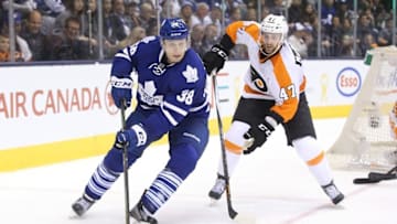 Feb 20, 2016; Toronto, Ontario, CAN; Toronto Maple Leafs center Colin Greening (38) skates around the net with the puck as Philadelphia Flyers defenseman Andrew MacDonald (47) pursues him at Air Canada Centre. The Flyers beat the Maple Leafs 5-4 in overtime. Mandatory Credit: Tom Szczerbowski-USA TODAY Sports
