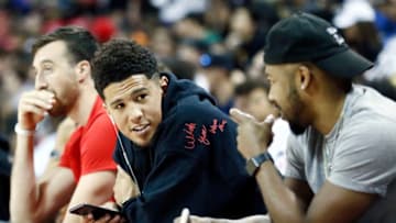 LAS VEGAS, NV - JULY 7: Devin Booker #1 of the the Phoenix Suns sits court side during the game against the the New York Knicks during Day 3 of the 2019 Las Vegas Summer League on July 7, 2019 at the Thomas & Mack Center in Las Vegas, Nevada. NOTE TO USER: User expressly acknowledges and agrees that, by downloading and/or using this Photograph, user is consenting to the terms and conditions of the Getty Images License Agreement. Mandatory Copyright Notice: Copyright 2019 NBAE (Photo by Chris Elise/NBAE via Getty Images)