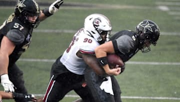 Vanderbilt quarterback Ken Seals (8) is sacked by South Carolina defensive lineman Rick Sandidge (90).Gw43366