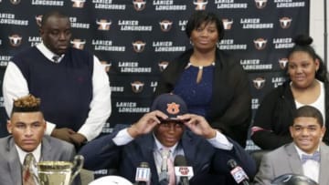 Feb 3, 2016; Buford, GA, USA; Lanier High School defensive tackle Derrick Brown commits to the Auburn Tigers at Auburn University during national signing day at Lanier High School. Also pictured are his parents James Brown, left, and Martha Brown, along with his sister Mikaelia Brown, right. Also pictured are Brown