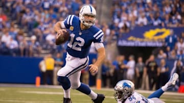 Sep 11, 2016; Indianapolis, IN, USA; Indianapolis Colts quarterback Andrew Luck (12) avoids the tackle of Detroit Lions defensive end Ezekiel Ansah (94) in the second half of the game at Lucas Oil Stadium. the Detroit Lions beat the Indianapolis Colts by the score of 39-35. Mandatory Credit: Trevor Ruszkowski-USA TODAY Sports