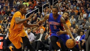 Dec 12, 2014; Phoenix, AZ, USA; Detroit Pistons guard Kentavious Caldwell-Pope (5) drives on Phoenix Suns forward Marcus Morris (15) and Eric Bledsoe (2) during the first quarter at US Airways Center. Mandatory Credit: Rick Scuteri-USA TODAY Sports