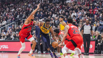 TORONTO, ON - MARCH 26: Jalen Smith #25 of the Indiana Pacers dribbles the ball to the basket against Khem Birch #24 of the Toronto Raptors (Photo by Mark Blinch/Getty Images)