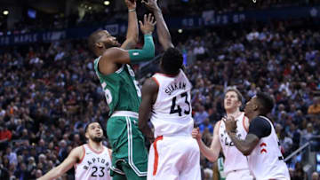 TORONTO, ON - APRIL 4: Greg Monroe #55 of the Boston Celtics shoots the ball as Pascal Siakam #43 of the Toronto Raptors defends during the second half of an NBA game at Air Canada Centre on April 4, 2018 in Toronto, Canada. NOTE TO USER: User expressly acknowledges and agrees that, by downloading and or using this photograph, User is consenting to the terms and conditions of the Getty Images License Agreement. (Photo by Vaughn Ridley/Getty Images)