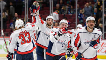 VANCOUVER, BC - OCTOBER 25: Alex Ovechkin #8 of the Washington Capitals celebrates with teammates Radko Gudas #33, and Dmitry Orlov #9 after winning their NHL game against the Vancouver Canucks at Rogers Arena October 25, 2019 in Vancouver, British Columbia, Canada. (Photo by Derek Cain/NHLI via Getty Images)