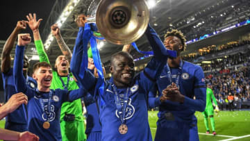 TOPSHOT - Chelsea's French midfielder N'Golo Kante (C) lifts the trophy after winning the UEFA Champions League final football match between Manchester City and Chelsea FC at the Dragao stadium in Porto on May 29, 2021. (Photo by David Ramos / POOL / AFP) (Photo by DAVID RAMOS/POOL/AFP via Getty Images)