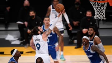 LOS ANGELES, CALIFORNIA - MARCH 16: Ricky Rubio #9 of the Minnesota Timberwolves scores on a layup between the Los Angeles Lakers defense during the second quarter at Staples Center on March 16, 2021 in Los Angeles, California. (Photo by Harry How/Getty Images) NOTE TO USER: User expressly acknowledges and agrees that, by downloading and or using this photograph, User is consenting to the terms and conditions of the Getty Images License Agreement.