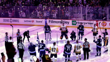Winnipeg Jets and Pittsburgh Penguins players raise their sticks Mandatory Credit: James Carey Lauder-USA TODAY Sports