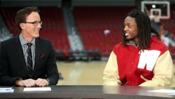 Dec 3, 2014; Madison, WI, USA; Wisconsin Badgers running back Melvin Gordon (right) prepares for an interview on ESPN Sports Center with ESPN anchor John Buccigross after the Wisconsin Badgers basketball game with the Duke Blue Devils at the Kohl Center. Duke defeated Wisconsin 80-70. Mandatory Credit: Mary Langenfeld-USA TODAY Sports