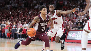 Feb 11, 2023; Fayetteville, Arkansas, USA; Mississippi State Bulldogs guard Shakeel Moore (3) dribbles in the lane against Arkansas Razorbacks guard Davonte Davis (4) during the first half at Bud Walton Arena. The Bulldogs won 70-64. Mandatory Credit: Nelson Chenault-USA TODAY Sports