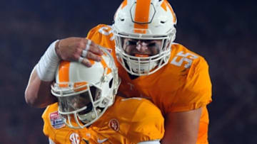 Sep 10, 2016; Bristol, TN, USA; Tennessee Volunteers quarterback Joshua Dobbs (11) celebrates with offensive lineman Coleman Thomas (55) after a touchdown during the first half against the Virginia Tech Hokies at Bristol Motor Speedway. Mandatory Credit: Christopher Hanewinckel-USA TODAY Sports
