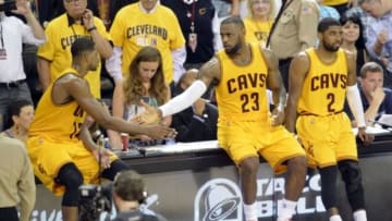 May 26, 2015; Cleveland, OH, USA; Cleveland Cavaliers center Tristan Thompson (13), forward LeBron James (23) and guard Kyrie Irving (2) wait to reenter the game during the third quarter against the Atlanta Hawks in game four of the Eastern Conference Finals of the NBA Playoffs at Quicken Loans Arena. Mandatory Credit: David Richard-USA TODAY Sports