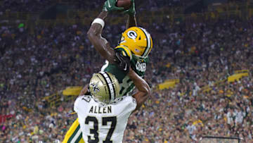 GREEN BAY, WISCONSIN - AUGUST 19: Romeo Doubs #87 of the Green Bay Packers catches a pass for a touchdown over Brian Allen #37 of the New Orleans Saints during the first half of a preseason game at Lambeau Field on August 19, 2022 in Green Bay, Wisconsin. (Photo by Stacy Revere/Getty Images)