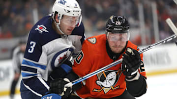 ANAHEIM, CALIFORNIA - NOVEMBER 29: Tucker Poolman #3 of the Winnipeg Jets pushes Nicolas Deslauriers #20 of the Anaheim Ducks during the second period of a game at Honda Center on November 29, 2019 in Anaheim, California. (Photo by Sean M. Haffey/Getty Images)