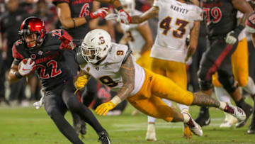 SAN DIEGO, CA - SEPTEMBER 15: Chase Jasmin #22 of the San Diego State Aztecs runs with the ball in the second half and is tackled by Jay Jay Wilson #9 of the Arizona State Sun Devils at SDCCU Stadium on September 15, 2018 in San Diego, California. (Photo by Kent Horner/Getty Images)