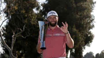 PACIFIC PALISADES, CALIFORNIA - FEBRUARY 19: Jon Rahm of Spain celebrates with the trophy after putting in to win The Genesis Invitational at Riviera Country Club on the 18th green on February 19, 2023 in Pacific Palisades, California. (Photo by Harry How/Getty Images)