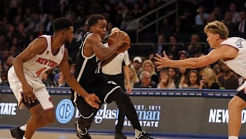 Oct 8, 2016; New York, NY, USA; Brooklyn Nets guard Yogi Ferrell (10) drives to the basket between New York Knicks forward Mindaugas Kuzminskas (91) and New York Knicks guard Chasson Randle (4) during the second half at Madison Square Garden. Mandatory Credit: Adam Hunger-USA TODAY Sports