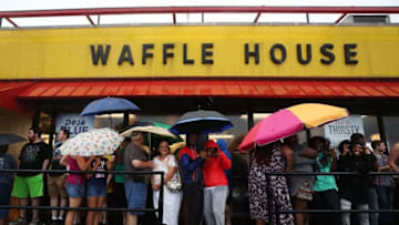WILMINGTON, NC - SEPTEMBER 15: People wait in the rain to enter a Waffle House a day after Hurricane Florence hit the area, on September 15, 2018 in Wilmington, North Carolina. Hurricane Florence made landfall in North Carolina as a Category 1 storm Friday and at least five deaths have been attributed to the storm, which continues to produce heavy rain and strong winds extending out nearly 200 miles. (Photo by Mark Wilson/Getty Images)