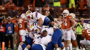 AUSTIN, TEXAS - NOVEMBER 13: The Kansas Jayhawks celebrate in the end zone after a reception for a two point conversion in overtime by Jared Casey #47 of the Kansas Jayhawks to defeat the Texas Longhorns at Darrell K Royal-Texas Memorial Stadium on November 13, 2021 in Austin, Texas. (Photo by Tim Warner/Getty Images)