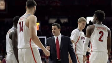 Nov 30, 2016; Tucson, AZ, USA; Arizona Wildcats head coach Sean Miller (C) talks to center Dusan Ristic (14) forward Lauri Markkanen (10) and guard Kobi Simmons (2) during the first half against the Texas Southern Tigers at McKale Center. Arizona won 85-63. Mandatory Credit: Casey Sapio-USA TODAY Sports