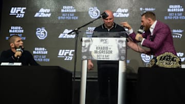 NEW YORK, NY - SEPTEMBER 20: UFC lightweight champion Khabib Nurmagomedov (L) and Conor McGregor (R) exchange words around UFC president Dana White (C) during the UFC 229 press conference at Radio City Music Hall on September 20, 2018 in New York City. Nurmagomedov and McGregor will meet in the main event on October 6, 2018 at the T-Mobile Arena in Las Vegas, Nevada. (Photo by Ed Mulholland/Zuffa LLC/Zuffa LLC via Getty Images)
