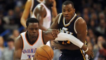 Jan 9, 2015; Oklahoma City, OK, USA; Utah Jazz guard Elijah Millsap (13) attempts to steal the ball from Oklahoma City Thunder guard Reggie Jackson (15) during the third quarter at Chesapeake Energy Arena. Mandatory Credit: Mark D. Smith-USA TODAY Sports