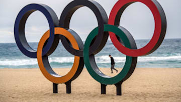 GANGNEUNG, SOUTH KOREA - FEBRUARY 02: A man walks past Olympic rings on the beach near the Gangneung Coastal Cluster on February 2, 2018 in Gangneung, South Korea. Finishing touches are being completed as teams begin to arrive from around the world to take part in the 23rd Winter Olympics. (Photo by Carl Court/Getty Images)
