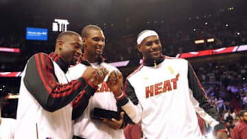 Oct 30, 2012; Miami, FL, USA; Miami Heat shooting guard Dwyane Wade (left) - power forward Chris Bosh (center) - small forward LeBron James (right) after receiving their NBA championship rings before a game against the Boston Celtics at American Airlines Arena. Mandatory Credit: Steve Mitchell-USA TODAY Sports
