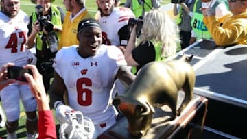 Oct 22, 2016; Iowa City, IA, USA; Wisconsin Badgers running back Corey Clement (6) is the first to the Heartland Trophy after their game against the Iowa Hawkeyes at Kinnick Stadium. The Badgers beat the Hawkeyes 17 to 9. Mandatory Credit: Reese Strickland-USA TODAY Sports