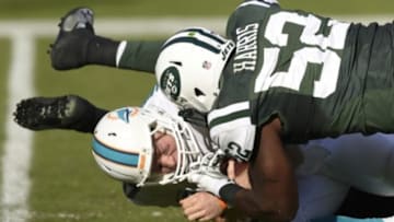 Dec 28, 2014; Miami Gardens, FL, USA; New York Jets inside linebacker David Harris (52) sacks Miami Dolphins quarterback Ryan Tannehill (17) in the second half at Sun Life Stadium. The Jets defeated Miami 37-24. Mandatory Credit: Brad Barr-USA TODAY Sports