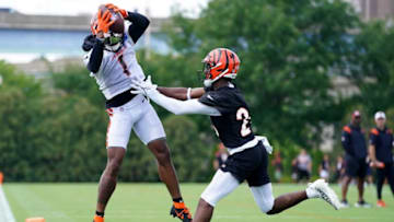 Cincinnati Bengals wide receiver Ja'Marr Chase (1) catches a pass as Cincinnati Bengals cornerback Eli Apple (20) defends during Cincinnati Bengals training camp practice, Monday, Aug. 1, 2022, at the practice fields next to Paul Brown Stadium in Cincinnati.Cincinnati Bengals Training Camp Aug 1 0038