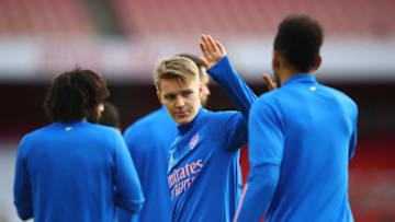 LONDON, ENGLAND - FEBRUARY 21: Martin Odegaard of Arsenal shakes hands with team mate Pierre Emerick Aubameyang during the warm up prior to the Premier League match between Arsenal and Manchester City at Emirates Stadium on February 21, 2021 in London, England. Sporting stadiums around the UK remain under strict restrictions due to the Coronavirus Pandemic as Government social distancing laws prohibit fans inside venues resulting in games being played behind closed doors. (Photo by Julian Finney/Getty Images)