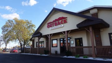 SKOKIE, ILLINOIS - NOVEMBER 02: A sign marks the location of an Outback Steakhouse restaurant on November 02, 2021 in Skokie, Illinois. Shares of Bloomin’ Brands, the parent company of Outback Steakhouse, closed down 10% today after the company said it expects $170 million in additional costs next year due to inflation. (Photo by Scott Olson/Getty Images)