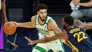 Feb 2, 2021; San Francisco, California, USA; Boston Celtics forward Jayson Tatum (0) handles the ball while being defended by Golden State Warriors forward Andrew Wiggins (22) during the third quarter at Chase Center. Mandatory Credit: Darren Yamashita-USA TODAY Sports