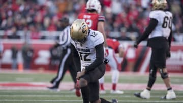 SALT LAKE CITY, UT - NOVEMBER 26: Brandon Lewis #12 of the Colorado Buffaloes lifts himself back up after being hit by the Utah Utes during their game November 26, 2021 at Rice-Eccles Stadium in Salt Lake City , Utah. (Photo by Chris Gardner/Getty Images)