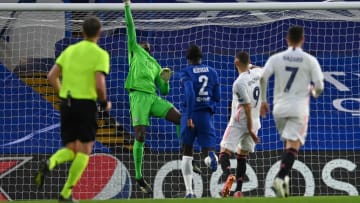 Chelsea's French-born Senegalese goalkeeper Edouard Mendy (2L) saves a shot from Real Madrid's French forward Karim Benzema (2R) during the UEFA Champions League second leg semi-final football match between Chelsea and Real Madrid at Stamford Bridge in London on May 5, 2021. (Photo by Glyn KIRK / AFP) (Photo by GLYN KIRK/AFP via Getty Images)