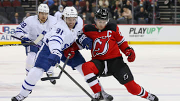 Toronto Maple Leafs center John Tavares (91) and New Jersey Devils center Nico Hischier (13) battle for the puck during the first period at Prudential Center. Mandatory Credit: Tom Horak-USA TODAY Sports