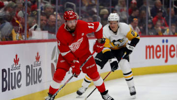 DETROIT, MICHIGAN - APRIL 02: Filip Hronek #17 of the Detroit Red Wings look to pass in front of Nick Bjugstad #27 of the Pittsburgh Penguins during the first period at Little Caesars Arena on April 02, 2019 in Detroit, Michigan. (Photo by Gregory Shamus/Getty Images)