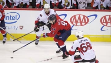 Jan 10, 2016; Washington, DC, USA; Washington Capitals defenseman Dmitry Orlov (9) controls the puck between Ottawa Senators center Mika Zibanejad (93) and left wing Mike Hoffman (68) during the second period at Verizon Center. Mandatory Credit: Rafael Suanes-USA TODAY Sports