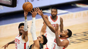 MINNEAPOLIS, MINNESOTA - MARCH 26: Karl-Anthony Towns #32 of the Minnesota Timberwolves goes after a rebound against Christian Wood #35 and Sterling Brown #0 of the Houston Rockets during the game at Target Center on March 26, 2021 in Minneapolis, Minnesota. The Timberwolves defeated the Rockets 107-101. NOTE TO USER: User expressly acknowledges and agrees that, by downloading and or using this Photograph, user is consenting to the terms and conditions of the Getty Images License Agreement (Photo by Hannah Foslien/Getty Images)