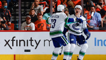 PHILADELPHIA, PENNSYLVANIA - OCTOBER 15: Vasily Podkolzin #92 (R) and Oliver Ekman-Larsson #23 of the Vancouver Canucks celebrate a goal by Podkolzin during the second period against the Philadelphia Flyers at Wells Fargo Center on October 15, 2021 in Philadelphia, Pennsylvania. (Photo by Tim Nwachukwu/Getty Images)