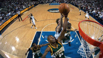 DALLAS - DECEMBER 9: Guard Ray Allen #34 of the Seattle Supersonics drives the ball against forward Dirk Nowitzki #41 of the Dallas Mavericks on December 9, 2004 at the American Airlines Center in Dallas, Texas. NOTE TO USER: User expressly acknowledges and agrees that, by downloading and/or using this Photograph, user is consenting to the terms and conditions of the Getty Images License Agreement. (Photo by Ronald Martinez/Getty Images)