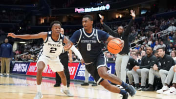 WASHINGTON, DC - JANUARY 01: Brandon Murray #0 of the Georgetown Hoyas dribbles by Eric Hunter Jr. #2 of the Butler Bulldogs in the first half during a college basketball game at the Capital One Arena on January 1, 2023 in Washington, DC. (Photo by Mitchell Layton/Getty Images)